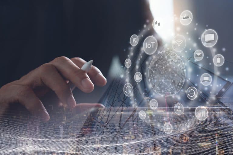 image of a laptop overlayed by IoT connectivity images