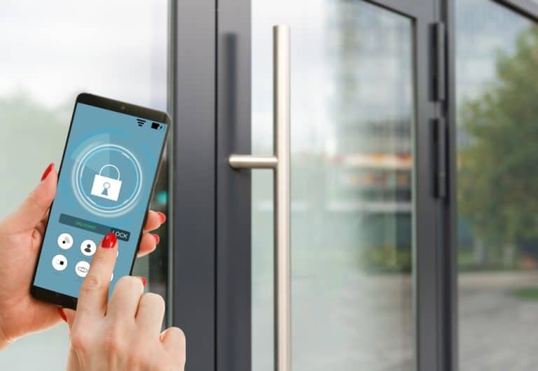 women outside office holding mobile phone